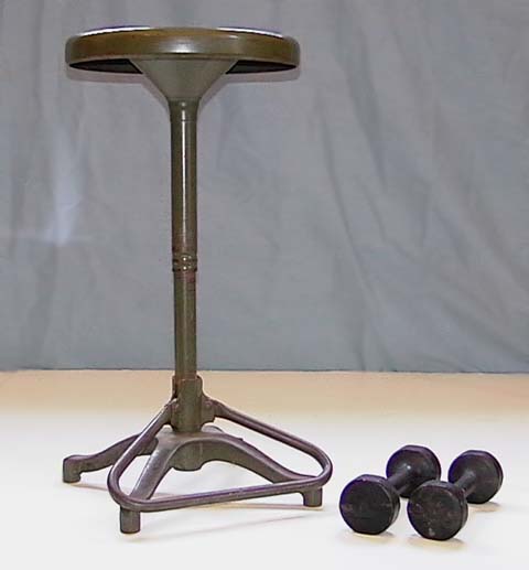 Demonstrator on a Rotating Stool with Dumbbells